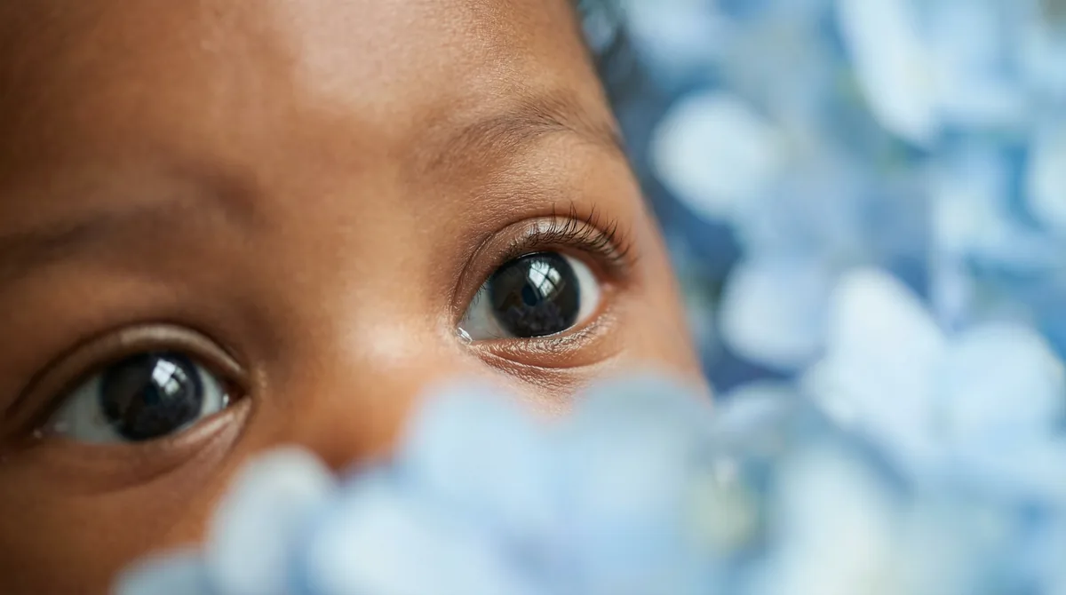 Artistic close-up of newborn baby with close up eyes hydrangea bokeh