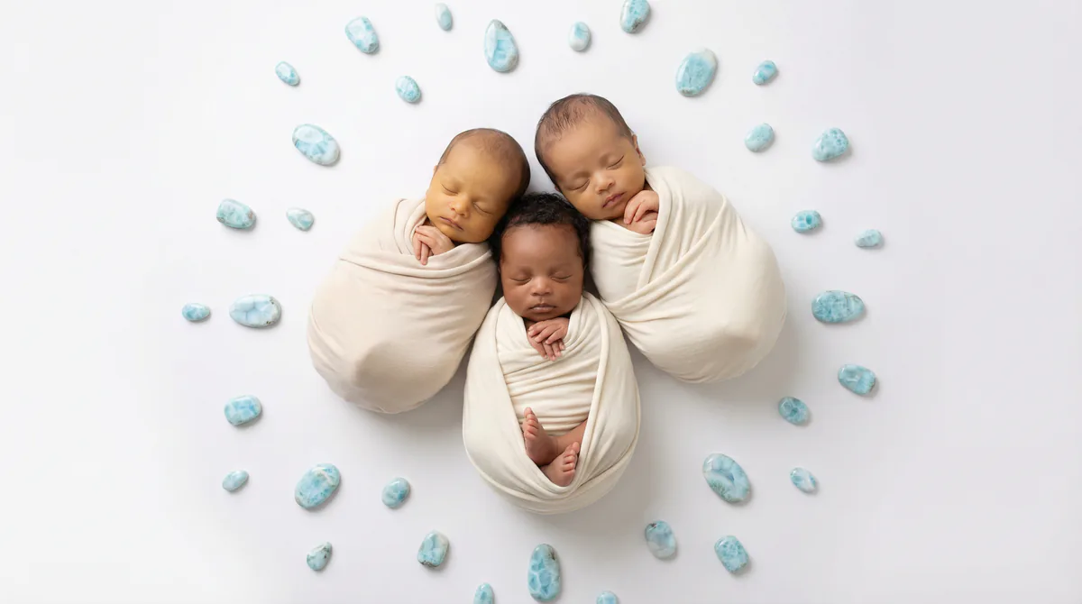 Diverse multicultural newborns in editorial fashion photoshoot with four newborns larimar gemstones