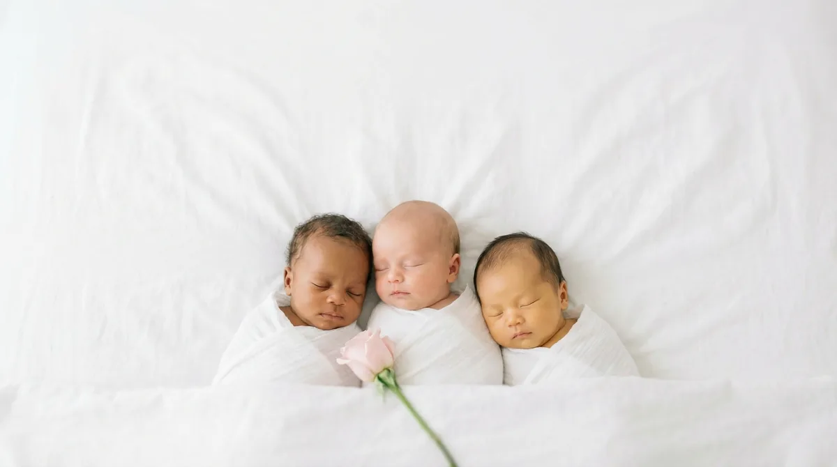 Group of newborn babies with minimal floral accents: group three babies single stem