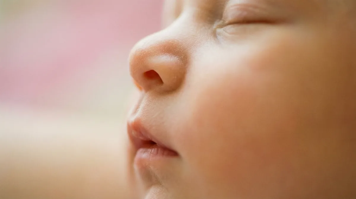Artistic close-up of newborn baby with macro lips nose profile