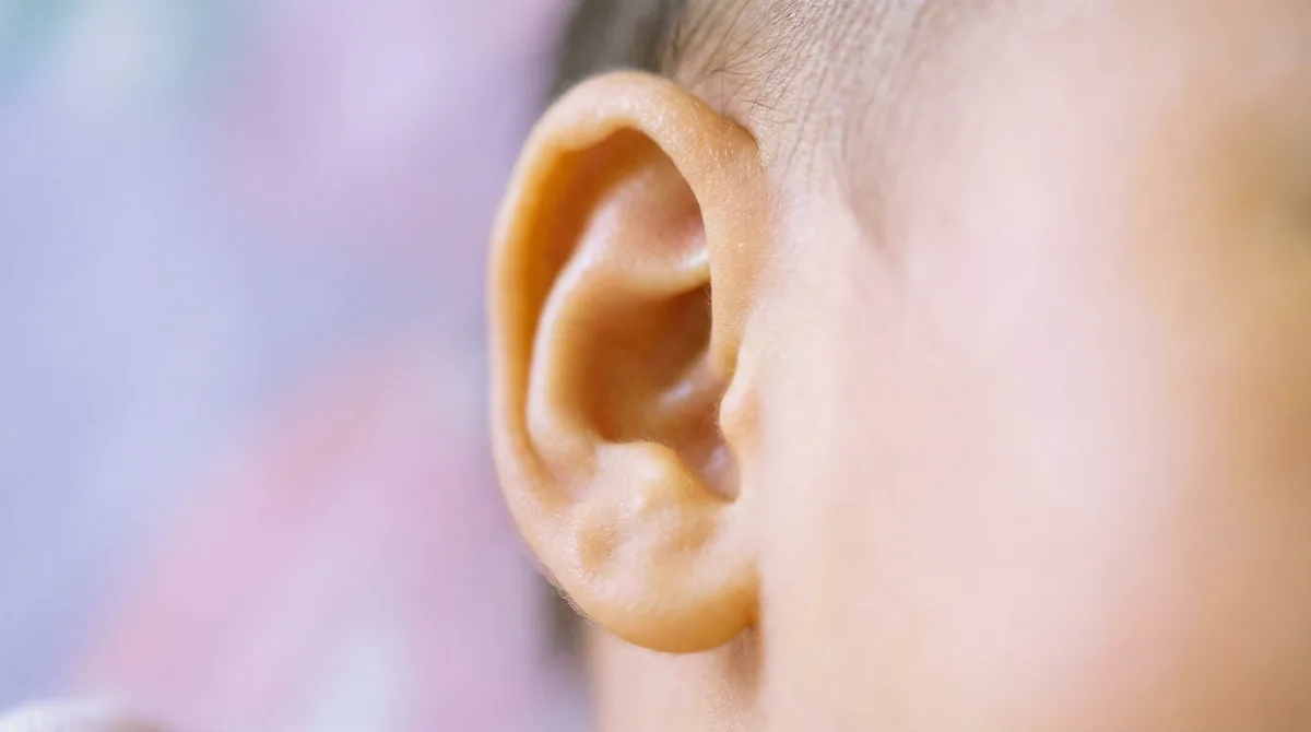 Artistic close-up of newborn baby with macro ear tiny details