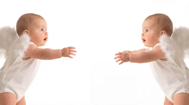 Editorial newborn fashion photoshoot with reaching angel v