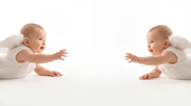 Editorial newborn fashion photoshoot with reaching angel v