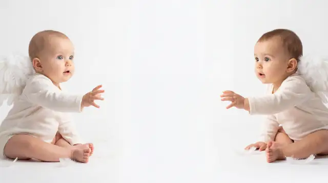 Editorial newborn fashion photoshoot with reaching angel v