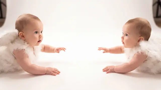 Editorial newborn fashion photoshoot with reaching angel v