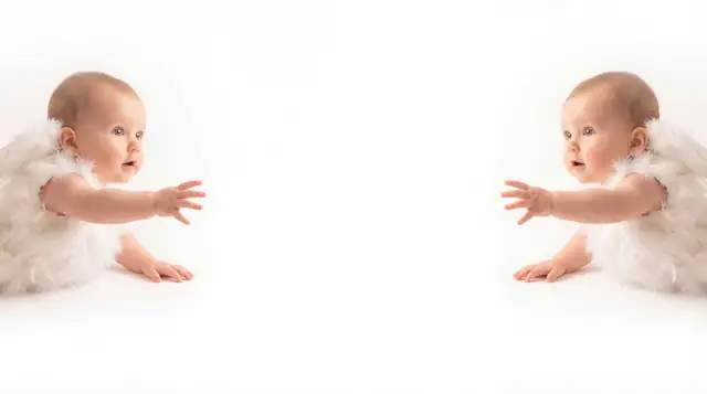 Editorial newborn fashion photoshoot with reaching angel v