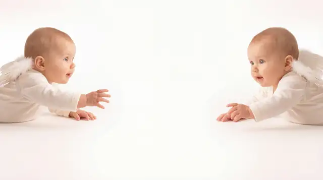 Editorial newborn fashion photoshoot with reaching angel v