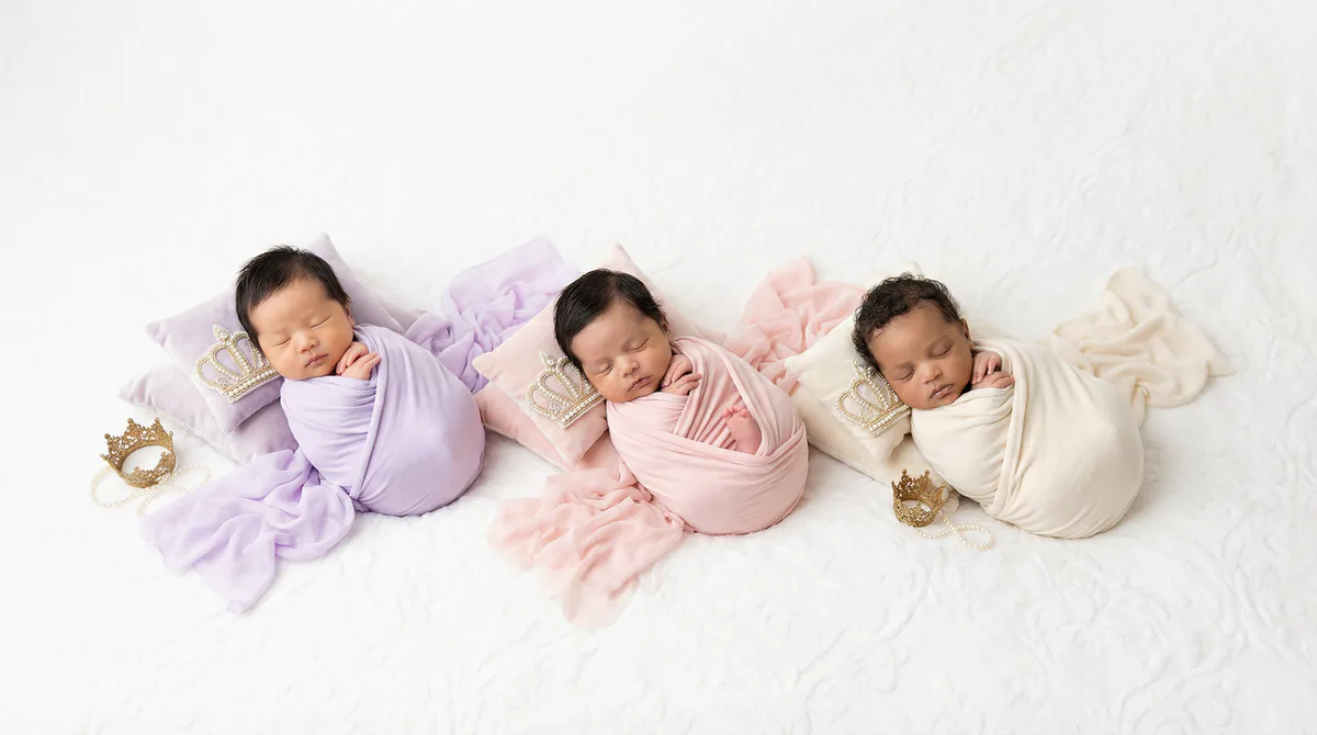Diverse multicultural newborns in editorial fashion photoshoot with three newborns