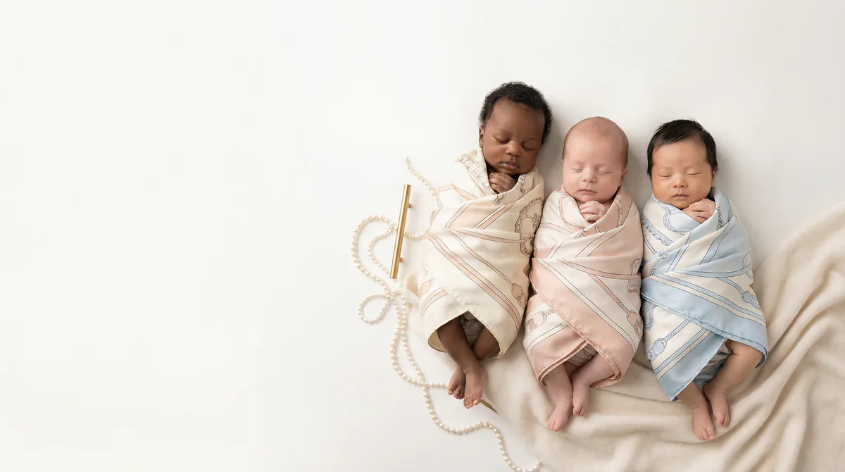 Diverse multicultural newborns in editorial fashion photoshoot with three newborns