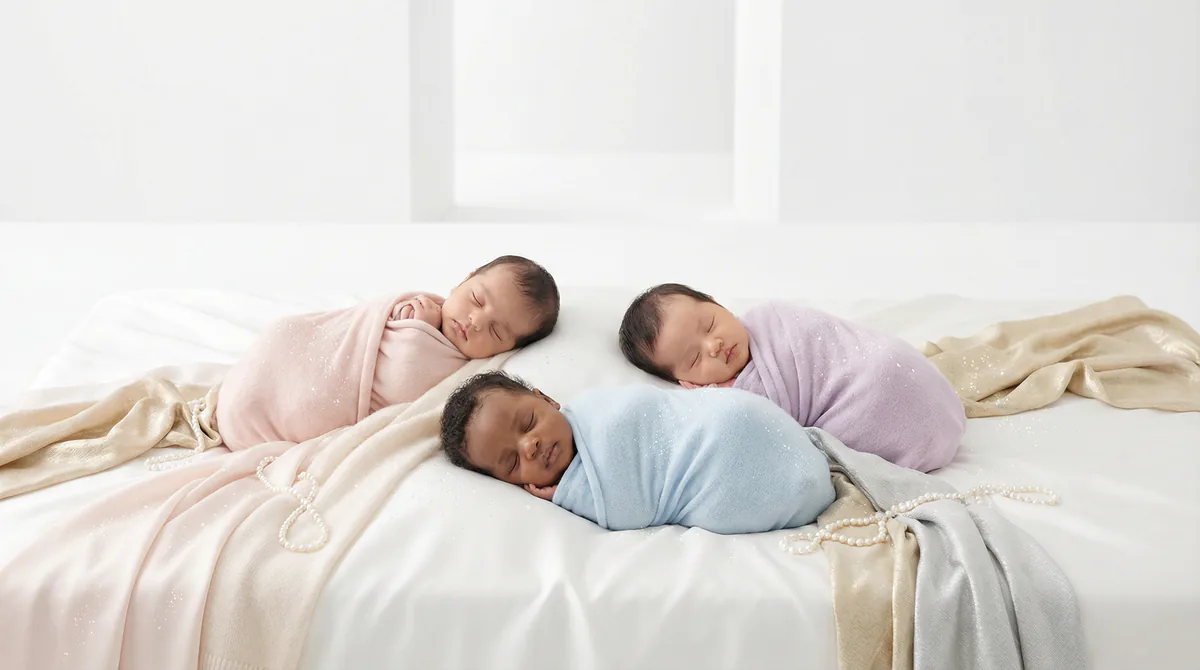 Diverse multicultural newborns in editorial fashion photoshoot with three newborns